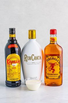 three bottles of rumchata, one with an egg in it