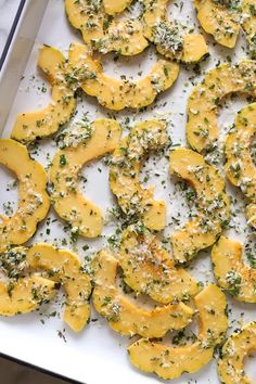 baked squash with herbs and cheese on a baking sheet ready to go into the oven