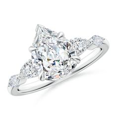 a diamond engagement ring with three stones on the band and an oval shaped center stone