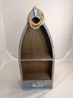 a boat shaped shelf with rope on top