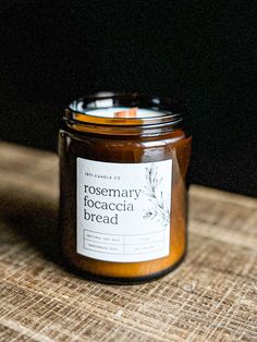 a close up of a jar of food on a wooden table with a black background