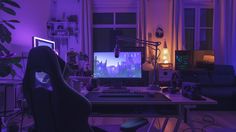 a computer desk with a monitor, keyboard and mouse in front of a purple lit room