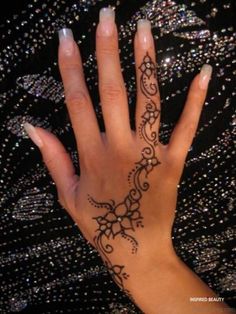 a woman's hand with a tattoo on it