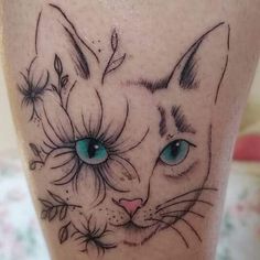 a close up of a cat with flowers on it's leg