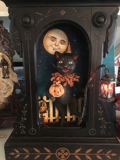 a clock with a black cat and pumpkins on it