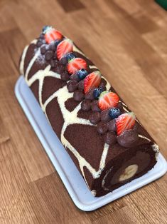 a piece of cake with chocolate and strawberries on it