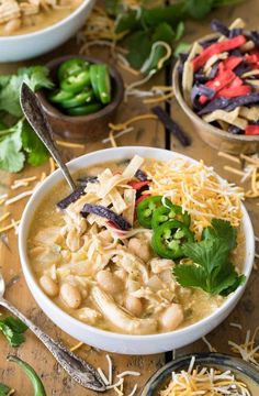 two bowls filled with chicken tortilla soup and garnished with cilantro