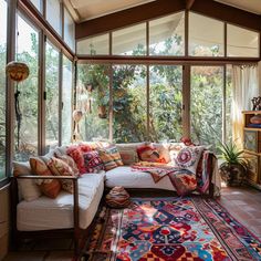 a living room filled with furniture and lots of windows