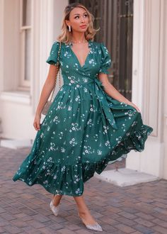 Fashionably Late The Lorelei Dress is nothing short of breathtaking. Its deep green hue is adorned with delicate floral prints, giving it a romantic yet classic feel. The wrap silhouette, flowing skirt, and bottom skirt tier create a flattering and graceful movement with every step. Finished with ruffle collar details and puff sleeves, this dress is ideal for any seasonal celebration. Pair it with your favorite heels or sandals for a versatile and effortless look. V-neckline Functional wrap style Elastic puff sleeve Ruffle collar True to size Model Details Content + Care 100% Polyester Dry Clean Only Try-On Video Lorelei Dress Try-On Video XS & XL Collar Details, Graceful Movement, Fashionably Late, Dress Designer, Seasonal Celebration, Flowing Skirt, Ruffle Collar, Designer Dress, Deep Green