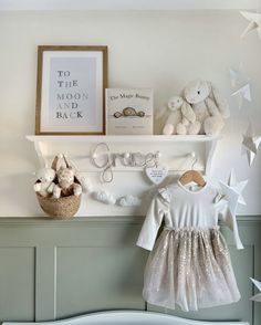 a baby's room is decorated in white and gray with stars on the wall