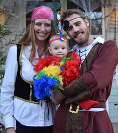 a man and woman dressed up as pirates with a baby