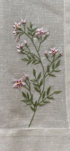 some pink flowers are on a white cloth