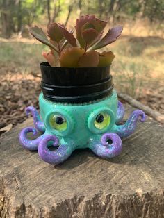 an octopus planter sitting on top of a tree stump