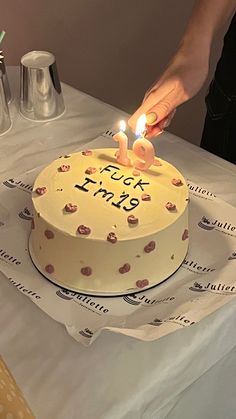 a person lighting candles on a birthday cake