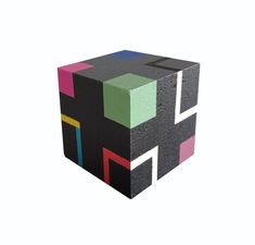 a cube made out of blocks with different colors and shapes on the sides, sitting in front of a white background