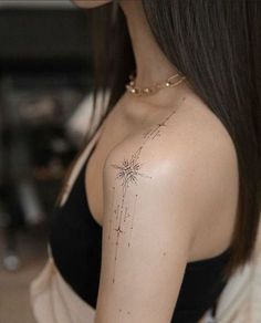 a woman with a star tattoo on her shoulder