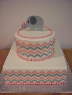 a pink elephant themed baby shower cake