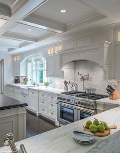 an image of a kitchen with white cabinets and marble counter tops, as well as the real house on twitter