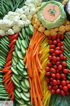 an assortment of fruits and vegetables are arranged in the shape of a dragon's tail