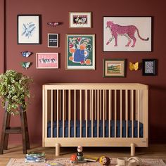 a baby crib with toys and pictures on the wall