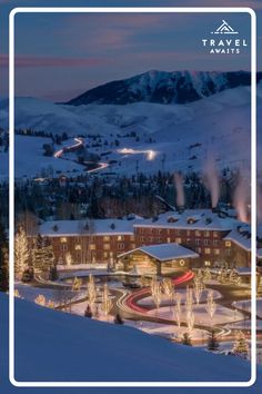 an aerial view of the resort and surrounding mountains at night with lights in the snow