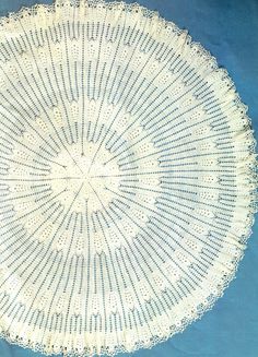 a white doily on a blue background