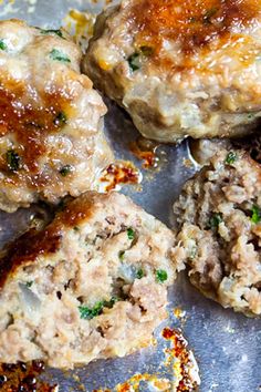 some meat patties are sitting on a pan