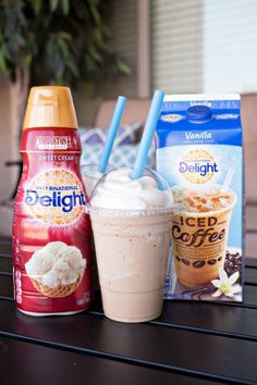 two drinks and three packets of ice cream on a table