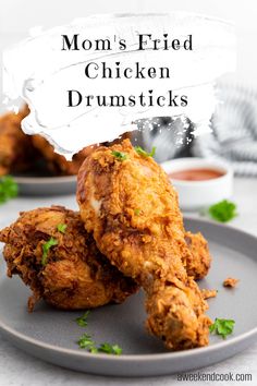 two fried chicken drums on a plate with parsley