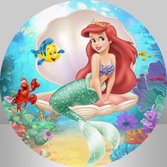 the little mermaid is sitting on top of an open book with fish and sea creatures around her