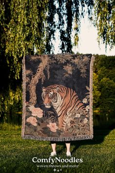 a woman standing in front of a tapestry with a tiger on it