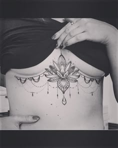 a woman's stomach with a tattoo on it