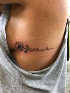 a woman with a tattoo on her chest that says, she's the sunflower