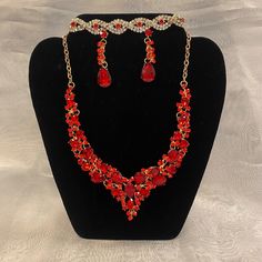 This Necklace Set Features A Gold Tone With Beautiful Red Crystal Accents. Comes With Necklace, Matching Earrings & Bracelet. Red Jewels Jewelry For Valentine's Day, Red Jeweled Jewelry For Valentine's Day, Red Party Jewelry With Jewels, Red Jewelry For Valentine's Day Party, Red Jeweled Valentine's Day Jewelry, Red Costume Jewelry For Valentine's Day, Red Valentine's Party Jewelry, Red Valentine's Day Jewelry, Red Metal Jewelry Sets For Party