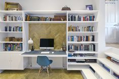 an office with bookshelves, desk and computer on the shelves in front of it