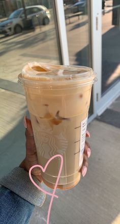 a woman holding up a cup of coffee