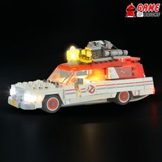 a toy car with lights on it is shown in the dark, and appears to be made out of legos