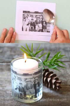 a person holding a lit candle in front of an old photo and pine cone on the table