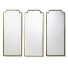 three white and gold framed mirrors on a white wall, each with an arched design