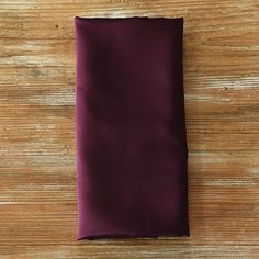 a purple pocket square on a wooden surface