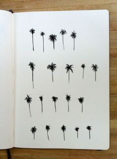 an open notebook with palm trees drawn on it