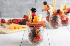 two mason jars filled with fruit and cheese