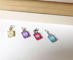 four different colored tags are attached to a keychain