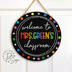 a welcome sign hanging on a door with polka dotes and the words welcome to mrs green's classroom