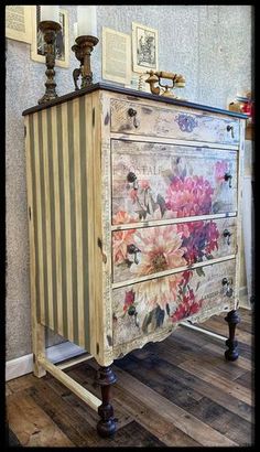 an old dresser with flowers painted on the front and sides, sitting in a room