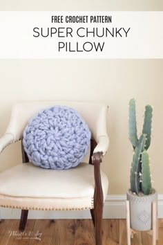 a white chair with a blue crochet pillow sitting on top of it next to a cactus