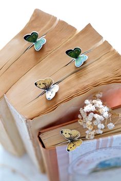 four butterflies are sitting on top of an open book