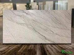 a white marble counter top sitting on top of a wooden floor in an office building