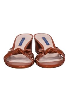 Step out in style with these Stuart Weitzman sandals! Crafted with luxe cognac tan leather and a knot detail, they'll add boho-chic vibes to any look. Pair them with a cozy floral frock and be ready for turning heads! Size 8 Made in Spain 100% Leather Knot front detail Heel height 2" Elegant Brown Summer Mules, Elegant Sandals With Leather Lining For Vacation, Elegant Brown Slip-on Sandals, Brown Sandals With Wrapped Block Heel, Synthetic Sandals With Leather Sole And Block Heel, Brown Padded Heel Sandals For Beach, Chic Leather Lined Sandals For Vacation, Brown Beach Sandals With Padded Heel, Brown Leather Sole Almond Toe Sandals