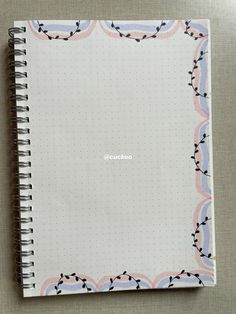 a spiral notebook with the word suko written on it in white and pink ink